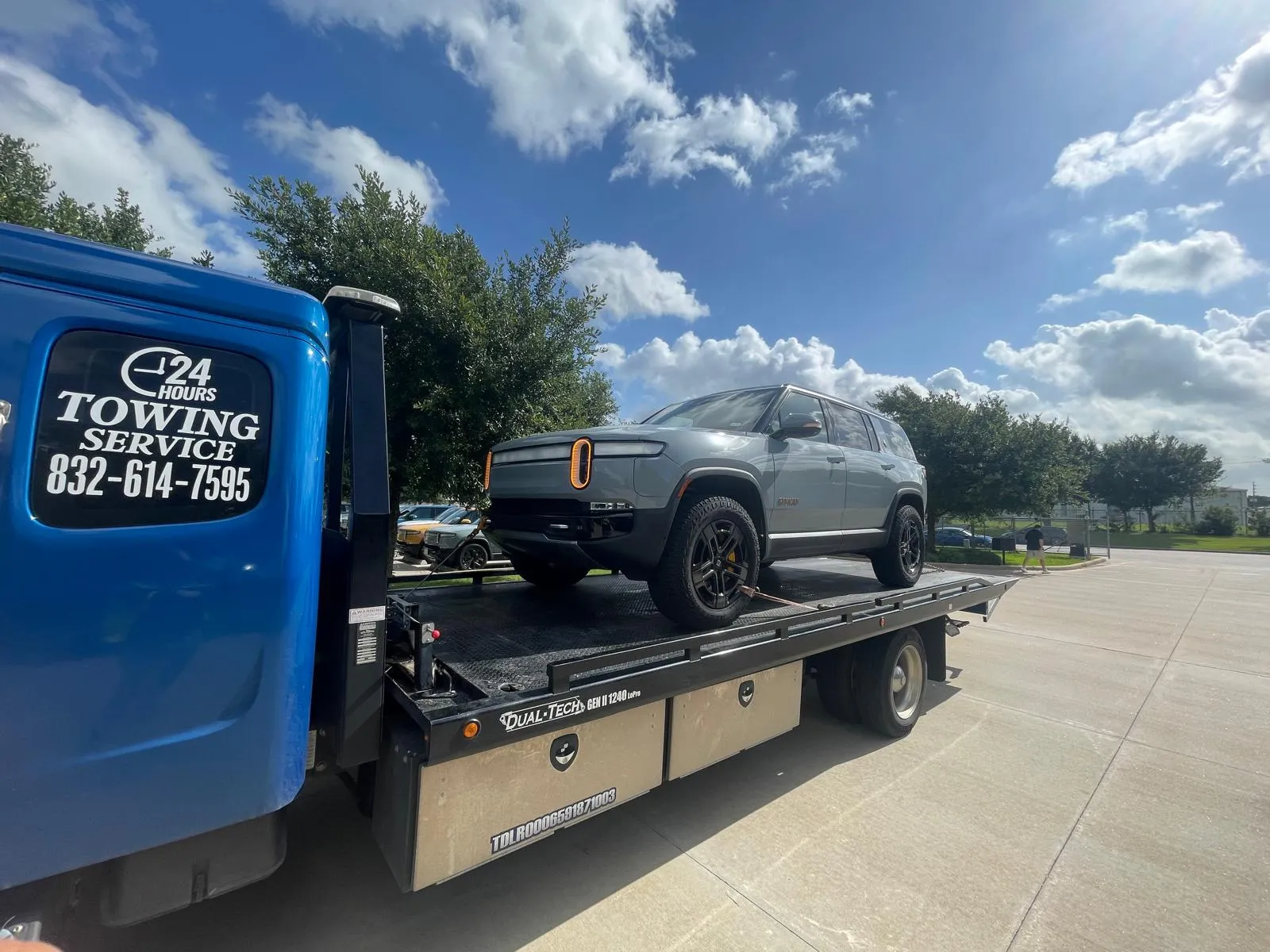Rivian electric SUV on flatbed tow truck in Houston TX