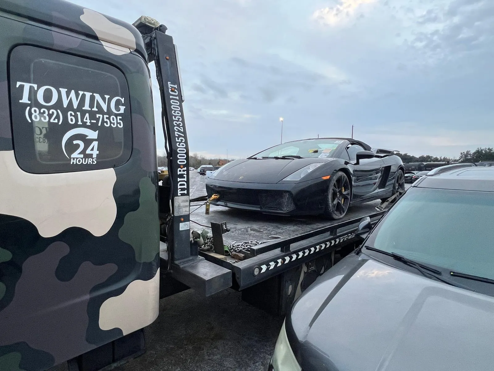 Lamborghini Gallardo securely strapped on flatbed for safe transport in Houston TX