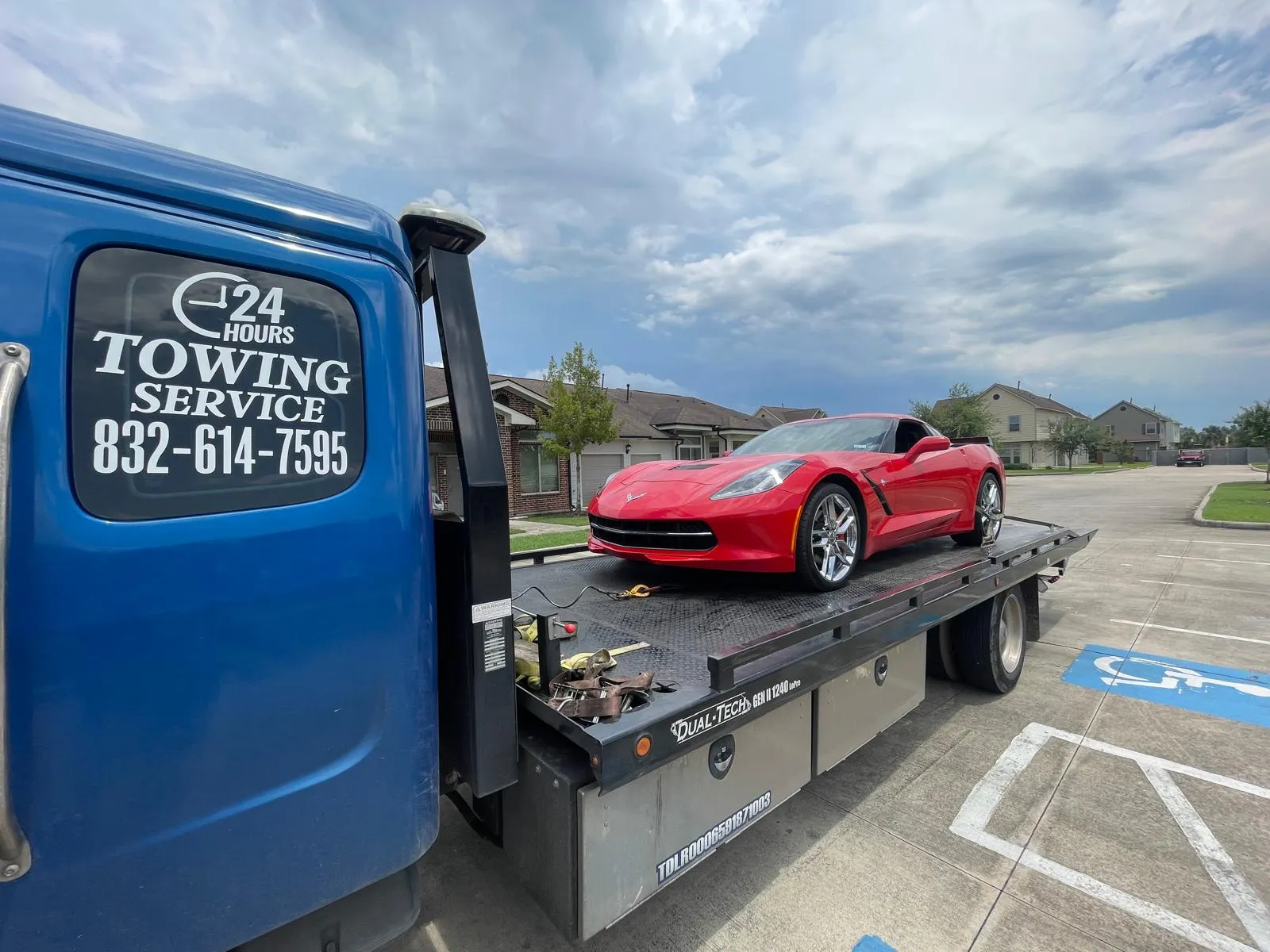 Red Corvette Stingray on flatbed tow truck in Houston TX