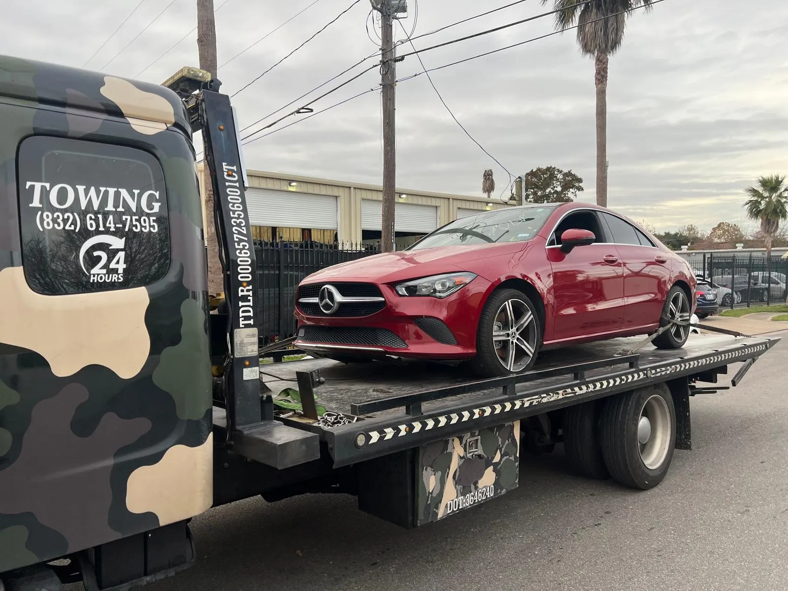 Red Mercedes-Benz CLA on flatbed tow truck in Houston TX