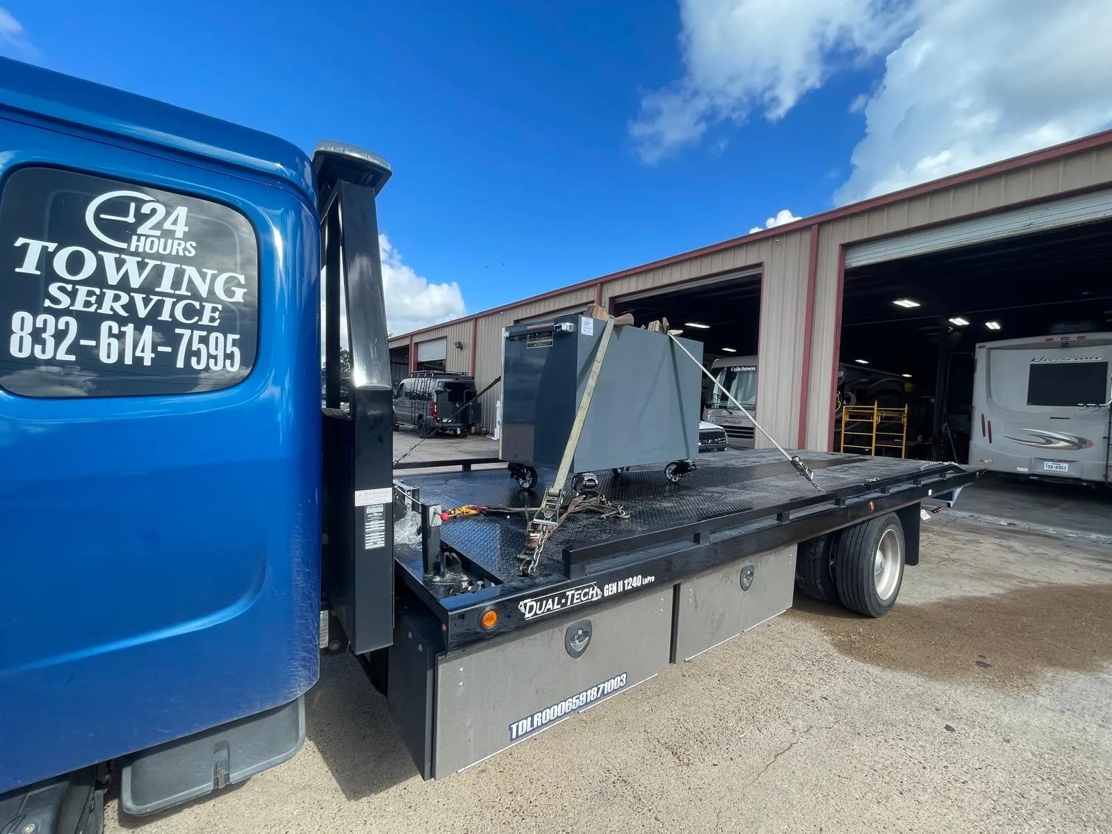 Prime Towing LLC flatbed tow truck equipment at Houston service depot