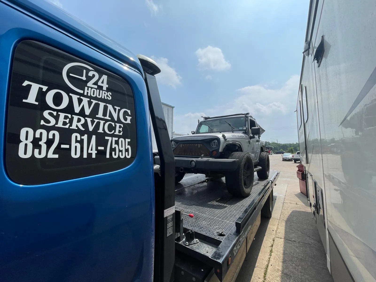 Jeep Wrangler on flatbed tow truck in Houston TX